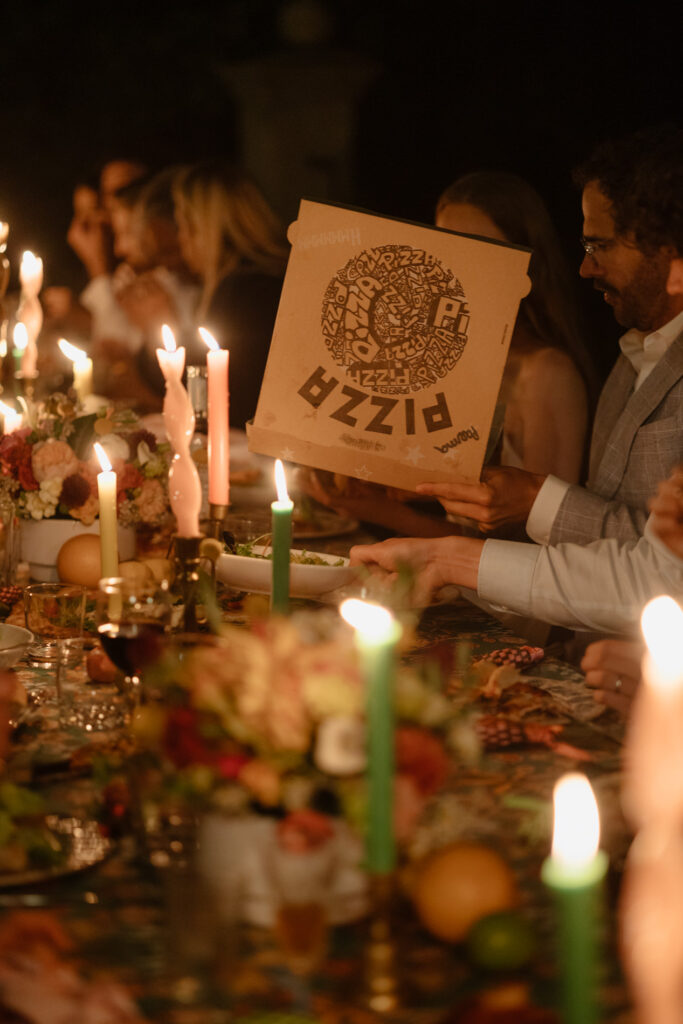 guests sharing pizza during intimate wedding celebration